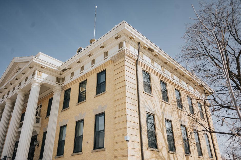 Low angle view of the historic Box Elder County Courthouse with columns and blue sky, Brigham City, Utah.
